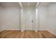 Bright hallway featuring light hardwood flooring and a classic white door at 3154 N Druid Hills Rd, Decatur, GA 30033