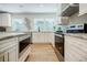 Modern kitchen features white cabinets, stainless steel appliances, granite countertops, and recessed lighting at 3154 N Druid Hills Rd, Decatur, GA 30033