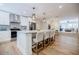 This contemporary kitchen offers a large island with seating, granite countertops, stainless appliances, and hardwood floors at 3154 N Druid Hills Rd, Decatur, GA 30033