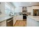 Bright kitchen with stainless appliances, granite countertops, white cabinets, hardwood floors, and recessed lighting at 3154 N Druid Hills Rd, Decatur, GA 30033