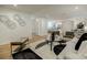 Bright living room boasts light wood floors, recessed lighting, and modern decor and is open to the kitchen at 3154 N Druid Hills Rd, Decatur, GA 30033