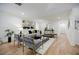 Bright living room with light floors, recessed lighting, a gray sofa, and modern decor at 3154 N Druid Hills Rd, Decatur, GA 30033
