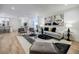 Spacious living room open to the kitchen has wood floors, recessed lights, and modern decor at 3154 N Druid Hills Rd, Decatur, GA 30033