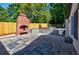 Outdoor fireplace with stone patio, raised planter, and privacy fence at 3154 N Druid Hills Rd, Decatur, GA 30033