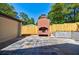 Outdoor fireplace with stone patio and privacy fence at 3154 N Druid Hills Rd, Decatur, GA 30033
