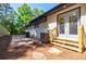 Back patio area featuring stone tiles, double doors, and lush landscaping at 3154 N Druid Hills Rd, Decatur, GA 30033