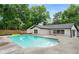 Backyard pool with patio and lush landscaping provides a private oasis for relaxing and entertaining at 3154 N Druid Hills Rd, Decatur, GA 30033