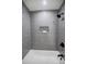 Modern shower with sleek gray herringbone tile, black fixtures, and a recessed niche at 3154 N Druid Hills Rd, Decatur, GA 30033