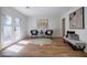 Bright sitting room boasts hardwood floors, neutral colors, and glass doors to the backyard at 3154 N Druid Hills Rd, Decatur, GA 30033
