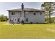 Spacious backyard with a patio, lush green grass, and trees at 3710 Burling Rdg, Lithonia, GA 30038