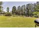 Large backyard featuring well-maintained lawn and mature trees at the perimeter, offering privacy and space at 3710 Burling Rdg, Lithonia, GA 30038