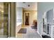Bright bathroom featuring a glass-enclosed shower and a separate soaking tub at 3710 Burling Rdg, Lithonia, GA 30038