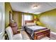 Cozy bedroom with a queen-sized bed, natural light, and hardwood floors at 3710 Burling Rdg, Lithonia, GA 30038
