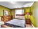 Comfortable bedroom with a queen bed, wood floors, and a decorative ceiling at 3710 Burling Rdg, Lithonia, GA 30038