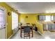 Bright dining area featuring an adjacent kitchen space with granite countertops and stainless steel appliances at 3710 Burling Rdg, Lithonia, GA 30038