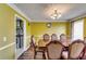 Elegant dining room with a large table, chandelier, and hardwood floors at 3710 Burling Rdg, Lithonia, GA 30038