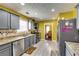 Well-equipped kitchen with modern appliances, granite countertops, and views into the dining room at 3710 Burling Rdg, Lithonia, GA 30038