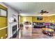 Open-concept living room features a fireplace, hardwood floors, and seamless transition into dining area at 3710 Burling Rdg, Lithonia, GA 30038