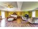 Expansive main bedroom suite featuring hardwood floors, seating area, and ample natural light at 3710 Burling Rdg, Lithonia, GA 30038