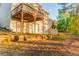 Rear exterior showcasing spacious yard with a raised deck and walkout basement at 4061 Preserve Trl, Snellville, GA 30039