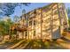 Back exterior view of the home, showcasing a wooden deck and lush, green yard with mature trees at 4061 Preserve Trl, Snellville, GA 30039