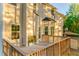 Back exterior view of home with wood deck, showing large yard and treed perimeter at 4061 Preserve Trl, Snellville, GA 30039