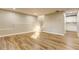 Expansive basement area with modern flooring, neutral walls, and access to an adjacent room at 4061 Preserve Trl, Snellville, GA 30039