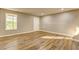 Basement area featuring stylish flooring, neutral walls, with a walkout door and a window at 4061 Preserve Trl, Snellville, GA 30039
