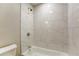 Bathroom showcasing a tub with white marble tiling and modern shower head at 4061 Preserve Trl, Snellville, GA 30039