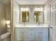 Bright bathroom featuring a double sink vanity with marble countertop and modern lighting fixtures at 4061 Preserve Trl, Snellville, GA 30039