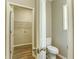 Half bath featuring white toilet and door to laundry room at 4061 Preserve Trl, Snellville, GA 30039