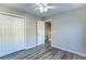 Bedroom featuring wood-look floors, a ceiling fan, closet, and neutral paint at 4061 Preserve Trl, Snellville, GA 30039