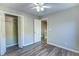 Bedroom featuring wood-look floors, a ceiling fan, and an open closet at 4061 Preserve Trl, Snellville, GA 30039