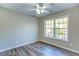 Bedroom features wood-look flooring, neutral paint, and window with backyard view at 4061 Preserve Trl, Snellville, GA 30039