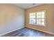 A bedroom featuring wood floors, neutral paint, and a view of the outdoors at 4061 Preserve Trl, Snellville, GA 30039