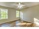 Bright bedroom features wood-look flooring, neutral paint, and a ceiling fan at 4061 Preserve Trl, Snellville, GA 30039