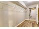 Walk-in closet featuring a built-in rack and a view into a utility room at 4061 Preserve Trl, Snellville, GA 30039