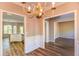 A dining room featuring wood floors, chair rails, and an elegant chandelier at 4061 Preserve Trl, Snellville, GA 30039