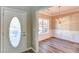 Inviting entryway with decorative front door and dining room featuring elegant chandelier at 4061 Preserve Trl, Snellville, GA 30039