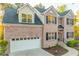 A two-story brick house featuring a manicured front yard and a two-car garage on a sunny day at 4061 Preserve Trl, Snellville, GA 30039