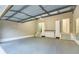 Spacious garage with epoxy flooring, built in storage, and stairs leading to an interior door at 4061 Preserve Trl, Snellville, GA 30039