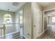 Upstairs hallway features wood-look flooring, arched window, and white railing at 4061 Preserve Trl, Snellville, GA 30039