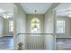 Hallway with view of arched window and rooms with ceiling fans at 4061 Preserve Trl, Snellville, GA 30039