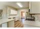 Modern kitchen with white cabinets, stainless appliances, and view to the dining area at 4061 Preserve Trl, Snellville, GA 30039