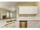 Open-concept kitchen with stone countertops and view to the living area at 4061 Preserve Trl, Snellville, GA 30039