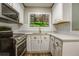 Bright kitchen with white cabinets, backsplash and range at 4061 Preserve Trl, Snellville, GA 30039