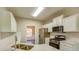Bright kitchen with stainless steel appliances, white cabinets, and stylish backsplash at 4061 Preserve Trl, Snellville, GA 30039