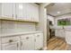 Bright kitchen features white cabinets, granite countertops, and subway tile backsplash at 4061 Preserve Trl, Snellville, GA 30039