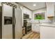Kitchen with stainless steel appliances, white cabinets, and unique faux window view at 4061 Preserve Trl, Snellville, GA 30039