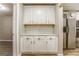 Kitchen pantry with shaker cabinets, granite counters, a subway tile backsplash and a stainless steel refrigerator at 4061 Preserve Trl, Snellville, GA 30039